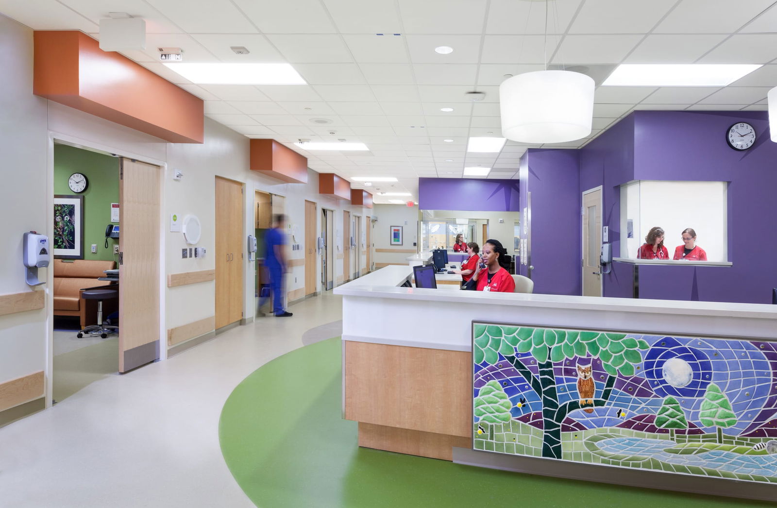 A Riley Children's Hospital lobby featuring vibrant tile walls and a large, colorful mural, creating a welcoming and cheerful atmosphere. This image showcases BSA's expertise in designing spaces that prioritize patient care.