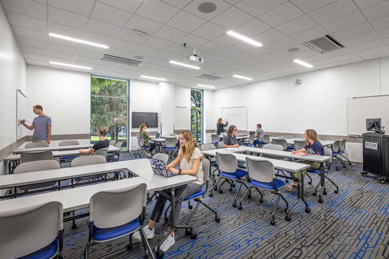 A modern classroom with multiple sets of tables arranged in