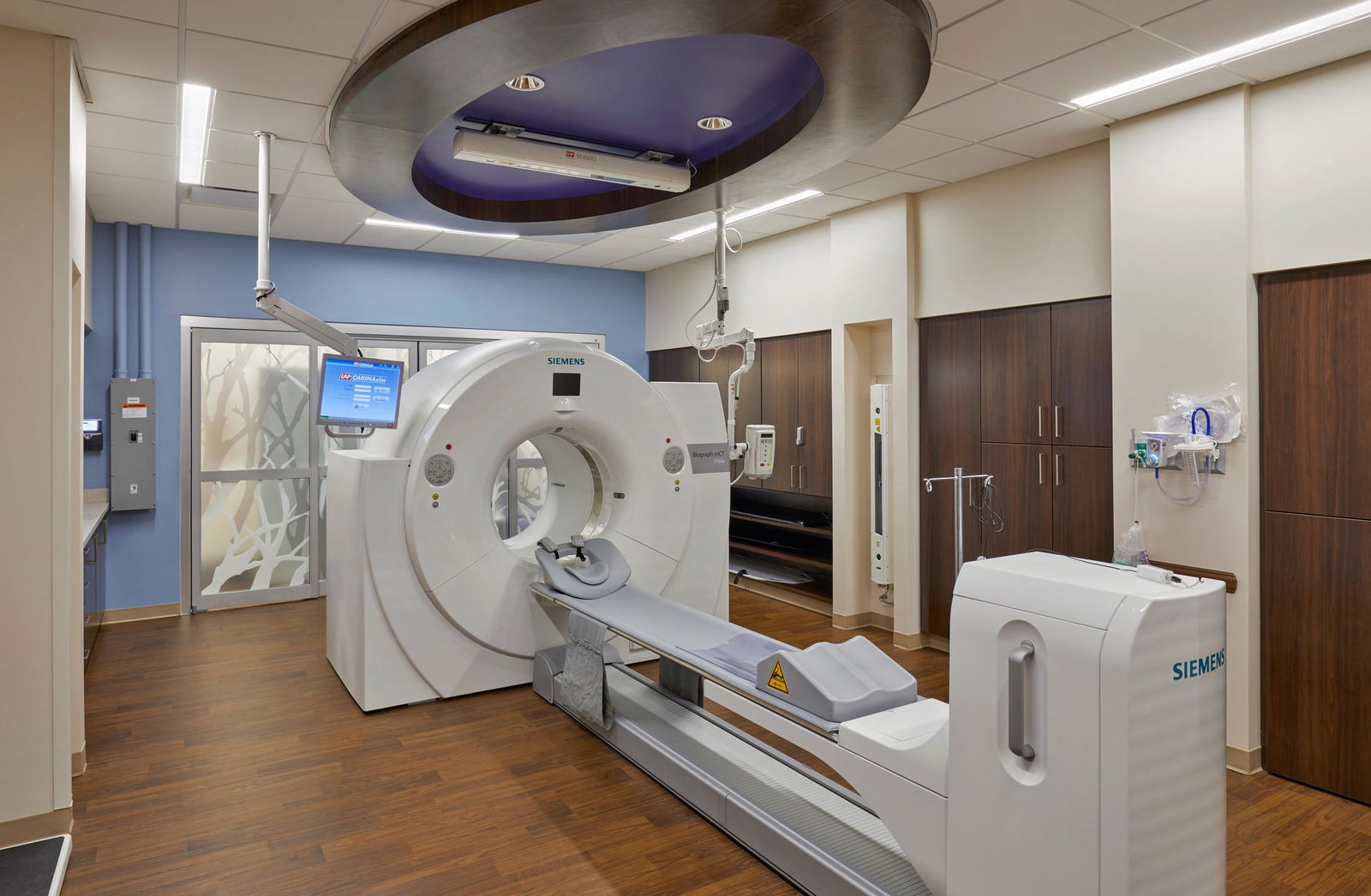 An imaging room within Community Health Network's MD Anderson Cancer Center - North, featuring a large medical machine, equipped with various monitors and medical supplies. This image showcases BSA's expertise in designing spaces that prioritize patient care and function.