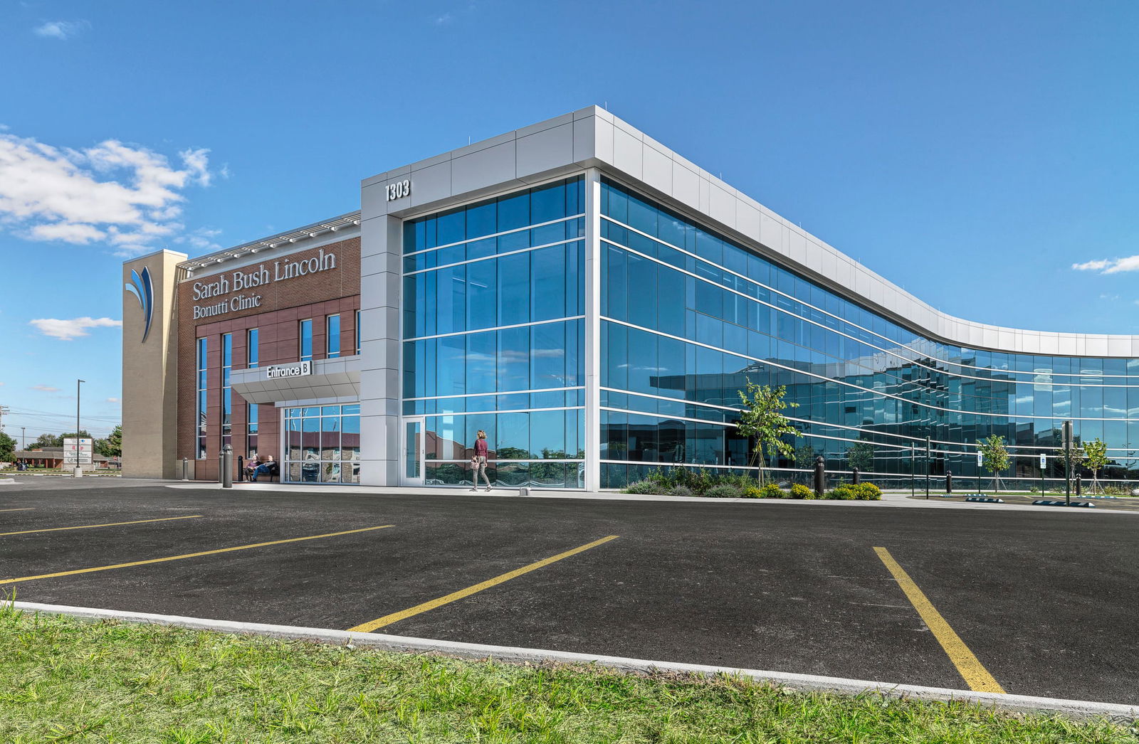 SBL Bonutti Clinic Exterior View featuring modern, sleek architecture and a curved glass exterior. This image showcases BSA's expertise in exterior architecture.